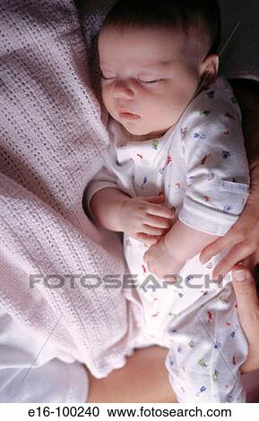 Mother holding sleeping newborn View Large Photo Image Stock Image - Mother holding sleeping newborn. Fotosearch