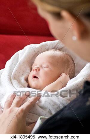 Mother holding sleeping newborn View Large Photo Image Stock Photography - Mother holding sleeping newborn. Fotosearch
