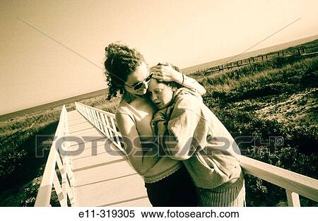 Stock Photography - Mother hugs daughter. Long Island. NY. Fotosearch