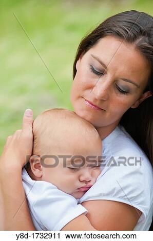 Mother in her 30s holding her baby boy of nine months View Large Photo Image Stock Image - Mother in her 30s holding her baby boy of nine months. Fotosearch