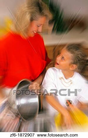 Mother in her 30s in kitchen with daughter washing dishes together for relaxation and talking View Large Photo Image Stock Photo - Mother in her 30s in kitchen with daughter washing dishes together for relaxation and talking. Fotosearch