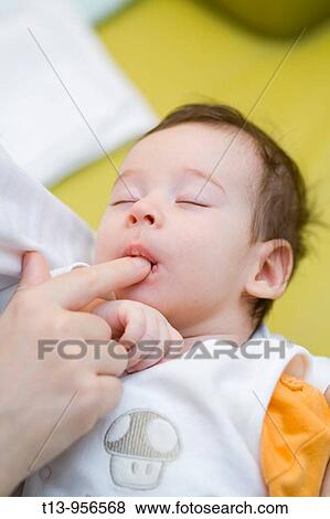 Mother is holding her one month old infant boy View Large Photo Image Stock Photo - Mother is holding her one month old infant boy. Fotosearch