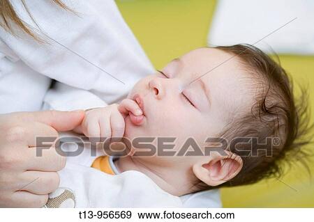 Mother is holding her one month old infant boy View Large Photo Image Stock Photo - Mother is holding her one month old infant boy. Fotosearch
