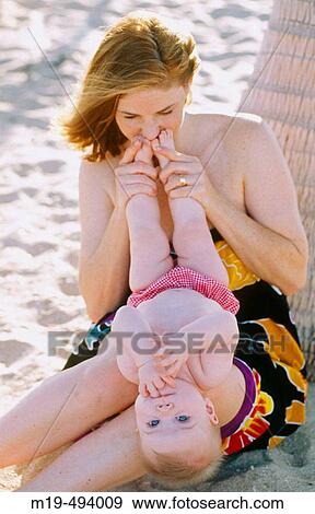 mother kissing her babies feet View Large Photo Image Stock Photo - mother kissing her babies feet. Fotosearch
