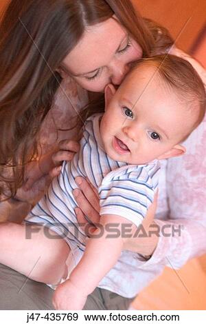 Mother kissing the neck of 5 month old boy, boy smiling View Large Photo Image Stock Photo - Mother kissing the neck of 5 month old boy, boy smiling. Fotosearch