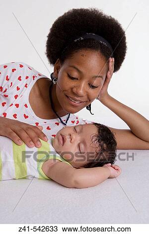Mother looking at her sleeping baby. View Large Photo Image Stock Image - Mother looking at her sleeping baby.. Fotosearch