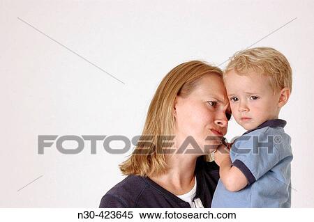 Mother looking sadly at son View Large Photo Image Stock Photography - Mother looking sadly at son. Fotosearch
