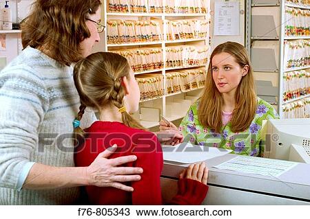 Mother, making appointment for her daughter, with receptionist, at medical office View Large Photo Image Stock Image - Mother, making appointment for her daughter, with receptionist, at medical office. Fotosearch