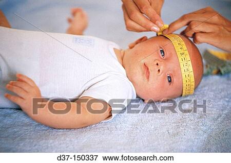 Stock Photo - Mother measuring baby's head. Fotosearch