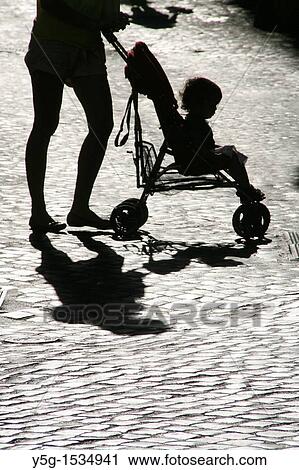 mother pushing pram buggy in street View Large Photo Image Stock Image - mother pushing pram buggy in street. Fotosearch