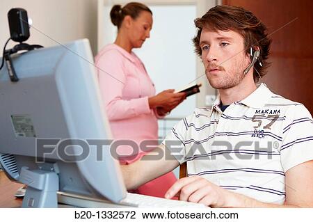 Mother reading and son looking at PC in room View Large Photo Image Stock Image - Mother reading and son looking at PC in room. Fotosearch
