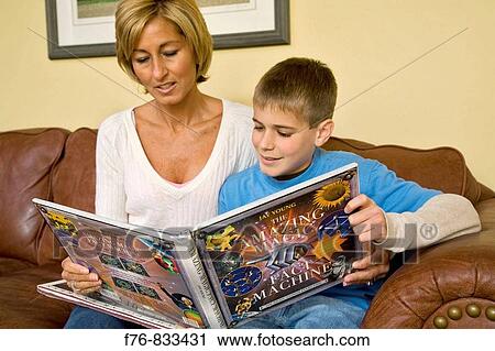 Mother reading book with her 14 year old son View Large Photo Image Stock Image - Mother reading book with her 14 year old son. Fotosearch