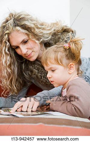 Stock Photo - Mother teaches young toddler girl. Fotosearch