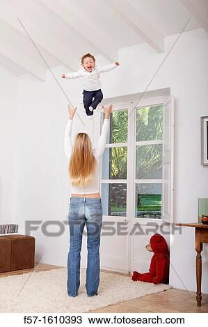 Mother throwing her one year old boy in the air View Large Photo Image Stock Image - Mother throwing her one year old boy in the air. Fotosearch