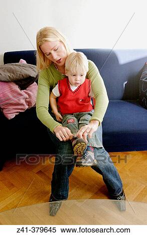 Stock Photography - Mother ties shoe-laces. Fotosearch