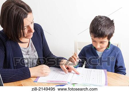 Mother tutoring young boy at home. View Large Photo Image Stock Photography - Mother tutoring young boy at home.. Fotosearch
