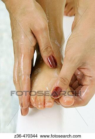 Mother washing daughter foot View Large Photo Image Picture - Mother washing daughter foot. Fotosearch