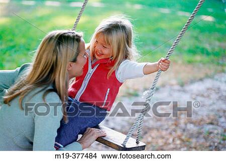 mother with daughter on a swing View Large Photo Image Picture - mother with daughter on a swing. Fotosearch