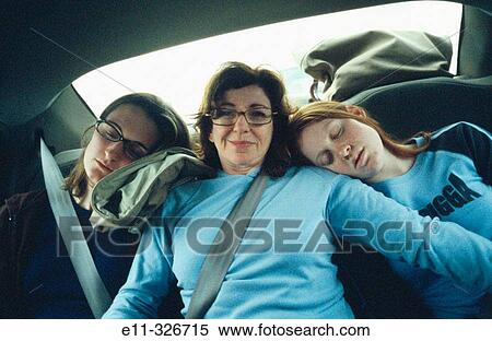 Mother with daughters traveling in back of car View Large Photo Image Stock Photography - Mother with daughters traveling in back of car. Fotosearch