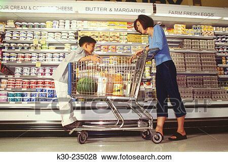 Mother with her child grocery shopping View Large Photo Image Stock Photo - Mother with her child grocery shopping. Fotosearch