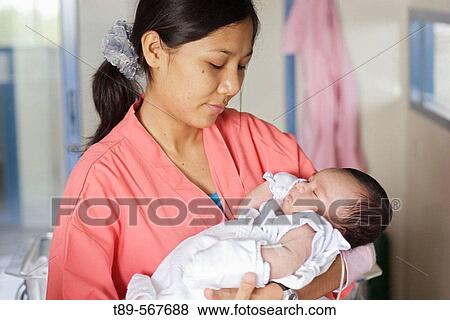 Mother with new born baby View Large Photo Image Stock Photo - Mother with new born baby. Fotosearch