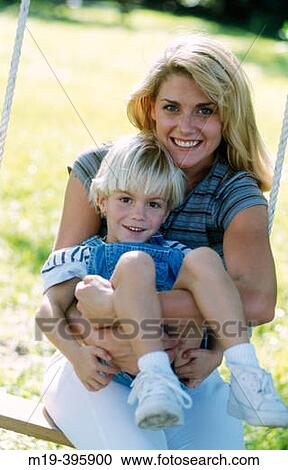 Stock Image - mother with son on a swing. Fotosearch