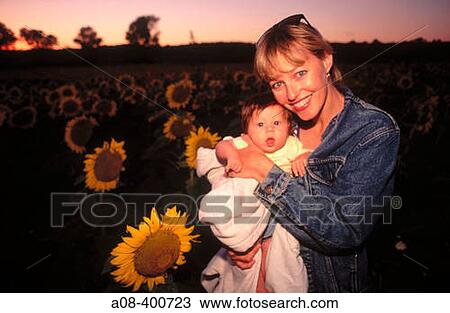 Mother with three month old daughter in sunflower field at sunset. USA. View Large Photo Image Stock Image - Mother with three month old daughter in sunflower field at sunset. USA.. Fotosearch