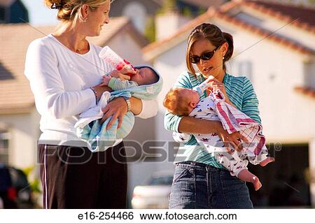 mothers bottle feeding babies View Large Photo Image Stock Photograph - mothers bottle feeding babies. Fotosearch