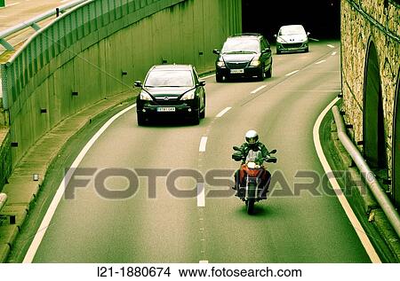 Motorcycle and cars driving around town. Ronda del Litoral, Barcelona, Catalonia, Spain. View Large Photo Image Picture - Motorcycle and cars driving around town. Ronda del Litoral, Barcelona, Catalonia, Spain.. Fotosearch