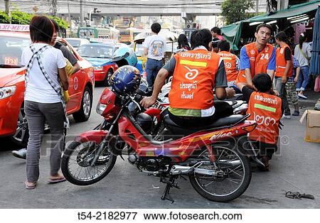 Motorcycle taxi drivers in Bangkok waiting for orders View Large Photo Image Stock Photo - Motorcycle taxi drivers in Bangkok waiting for orders. Fotosearch