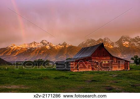 Moulton Barn at sunrise with rainbow on Mormon Row against the Teton Range Mountains in Grand Teton National Park. View Large Photo Image Stock Photograph - Moulton Barn at sunrise with rainbow on Mormon Row against the Teton Range Mountains in Grand Teton National Park.. Fotosearch
