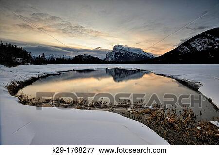 Stock Photo - Mount Rundle reflected in the Vermilion Lakes at dawn, Banff National Park, Alberta, Canada. Fotosearch