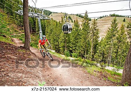mountain biking the River Run Trail on Bald Mountain under the Roundhouse Gondola at Sun Valley Resort near the city of Ketchum in central Idaho. View Large Photo Image Picture - mountain biking the River Run Trail on Bald Mountain under the Roundhouse Gondola at Sun Valley Resort near the city of Ketchum in central Idaho.. Fotosearch