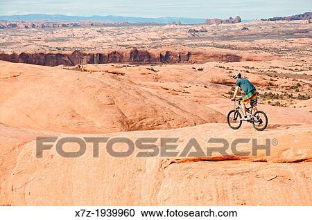 Mountain biking The Slickrock Trail on sandstone of the Colorado Plateau near the city of Moab in southern Utah. View Large Photo Image Stock Image - Mountain biking The Slickrock Trail on sandstone of the Colorado Plateau near the city of Moab in southern Utah.. Fotosearch