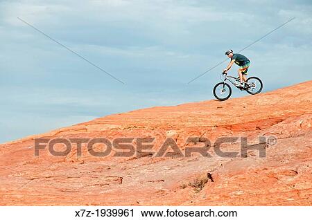 Stock Image - Mountain biking The Slickrock Trail on sandstone of the Colorado Plateau near the city of Moab in southern Utah.. Fotosearch