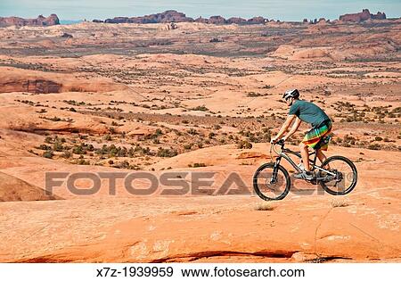 Mountain biking The Slickrock Trail on sandstone of the Colorado Plateau near the city of Moab in southern Utah. View Large Photo Image Stock Photo - Mountain biking The Slickrock Trail on sandstone of the Colorado Plateau near the city of Moab in southern Utah.. Fotosearch