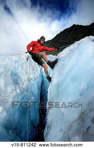 Mountain guide abseiling in glacier crevasse View Large Photo Image Stock Image - Mountain guide abseiling in glacier crevasse. Fotosearch