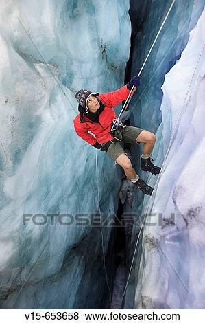 Mountain guide abseiling in glacier crevasse View Large Photo Image Stock Photo - Mountain guide abseiling in glacier crevasse. Fotosearch