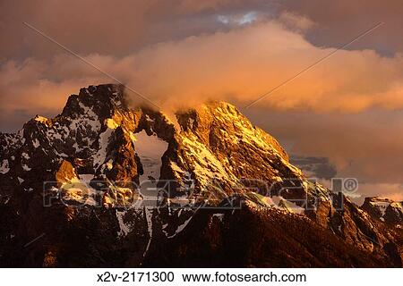 Mountain peak at sunrise in Grand Teton National Park. View Large Photo Image Stock Image - Mountain peak at sunrise in Grand Teton National Park.. Fotosearch