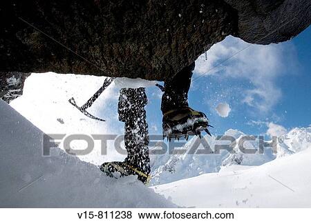 Mountaineer climbing snow covered mountain with crampons and ice axe View Large Photo Image Stock Photo - Mountaineer climbing snow covered mountain with crampons and ice axe. Fotosearch