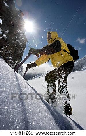 Mountaineer climbing snow covered mountain View Large Photo Image Stock Photography - Mountaineer climbing snow covered mountain. Fotosearch