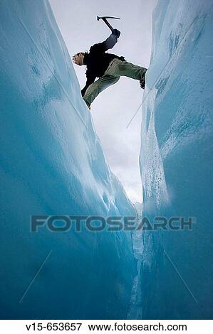 Mountaineer jumbing a crevasse on a glaicier View Large Photo Image Stock Photo - Mountaineer jumbing a crevasse on a glaicier. Fotosearch