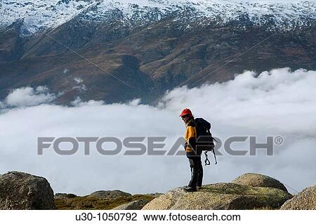 Stock Image - Mountaineer looking Jerte Valley from Sierra de Barco Mountains of Sierra de Gredos National Park? vila Castilla y Le? n Spain. Fotosearch