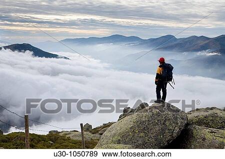 Stock Photo - Mountaineer looking Jerte Valley from Sierra de Barco Mountains of Sierra de Gredos National Park? vila Castilla y Le? n Spain. Fotosearch