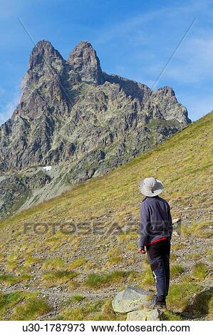 Stock Image - Mountaineer walking near Midi D? Ossau peak, in National Park des Pyrenees, in Bearn province Atlantics Pyrenees Aquitania, France Europe. Fotosearch