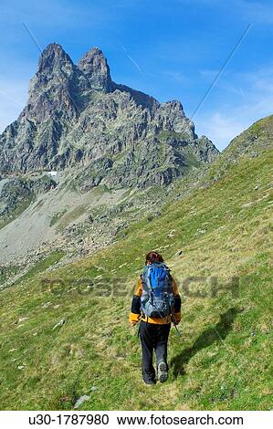 Stock Image - Mountaineer walking near Midi D? Ossau peak, in National Park des Pyrenees, in Bearn province Atlantics Pyrenees Aquitania, France Europe. Fotosearch