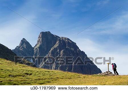 Stock Photo - Mountaineer walking near Midi D? Ossau peak, in National Park des Pyrenees, in Bearn province Atlantics Pyrenees Aquitania, France Europe. Fotosearch