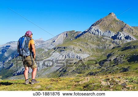 Mountaineer watching Agueri Peak 2 449 m from the ascent to Bisaur? n 2 676 m between Hecho valley and Arag? es valley Arag? es del Puerto, Arag? n Spain View Large Photo Image Stock Photograph - Mountaineer watching Agueri Peak 2 449 m from the ascent to Bisaur? n 2 676 m between Hecho valley and Arag? es valley Arag? es del Puerto, Arag? n Spain. Fotosearch