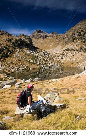 Stock Photo - mountaineer woman near a small lake Colomers glaciar cirque Aran Valley Pyrenees mountain range Lerida province Catalonia, Spain, Europe. Fotosearch