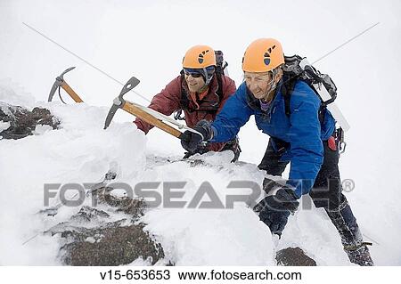 Mountaineers climbing snow covered mountain with crampons and ice axes View Large Photo Image Stock Image - Mountaineers climbing snow covered mountain with crampons and ice axes. Fotosearch